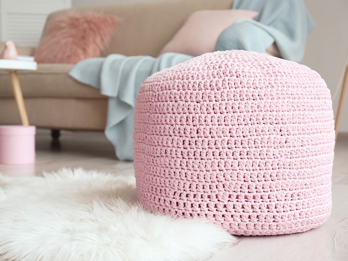 Living room with a pink pouf.